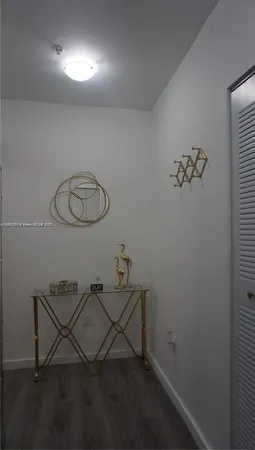 a bedroom with a lamp and a lamp on dresser