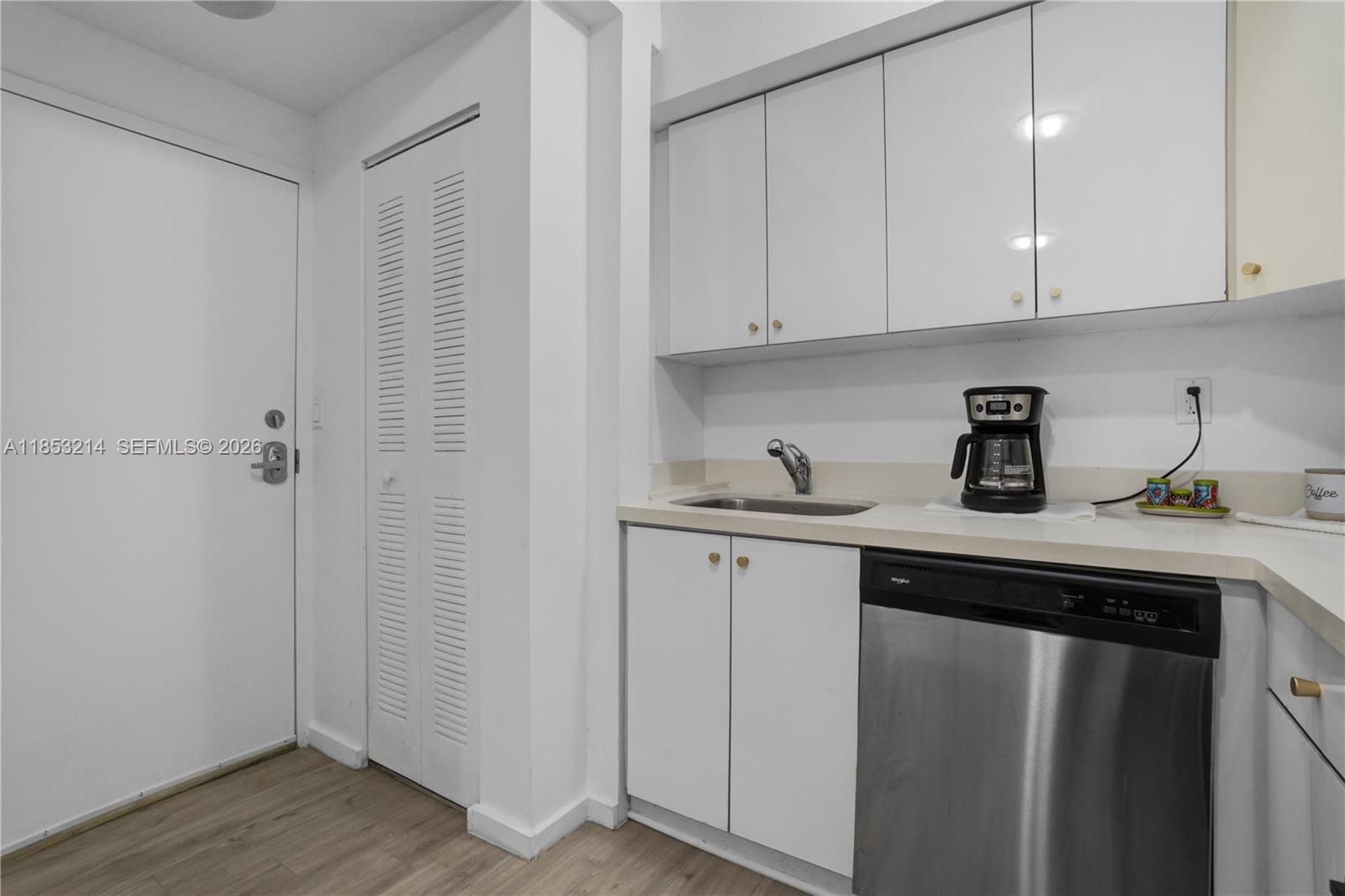 810 7th Street, Unit 107 Miami Beach, FL 33139 - Photo 10 of 36 a kitchen with a sink and cabinets