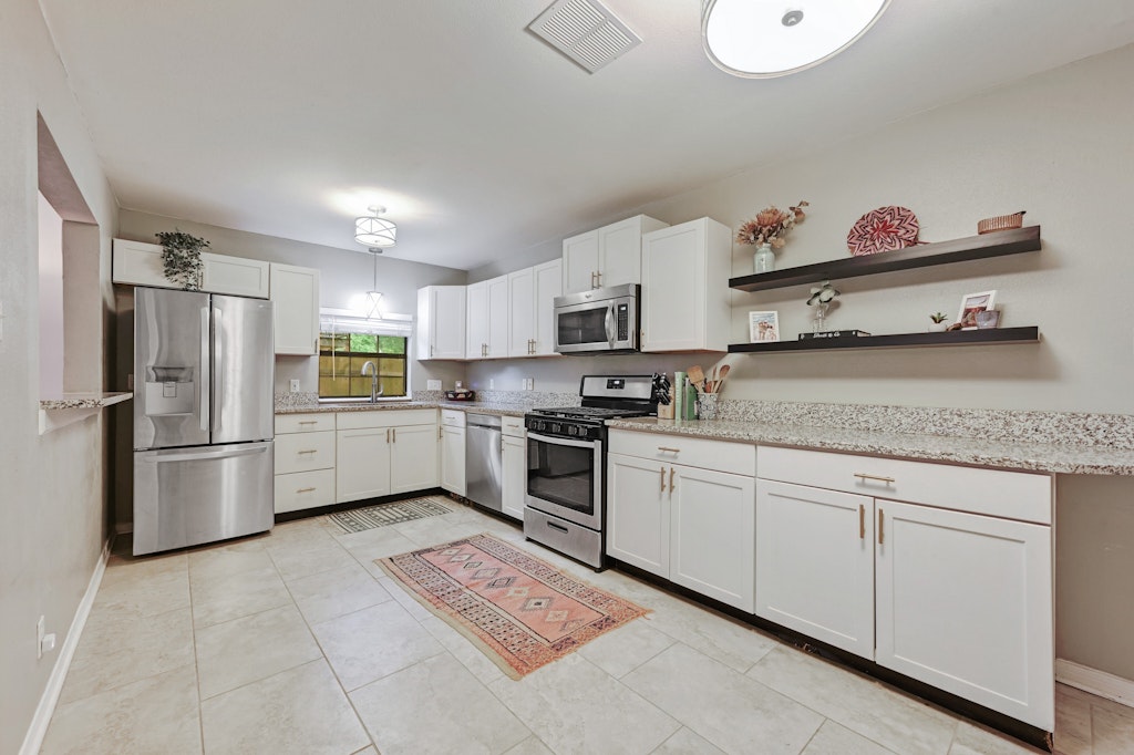 4025 Valley View Road, Unit 2 Austin, TX 78704 - Photo 8 of 19 a kitchen with granite countertop a refrigerator and a sink
