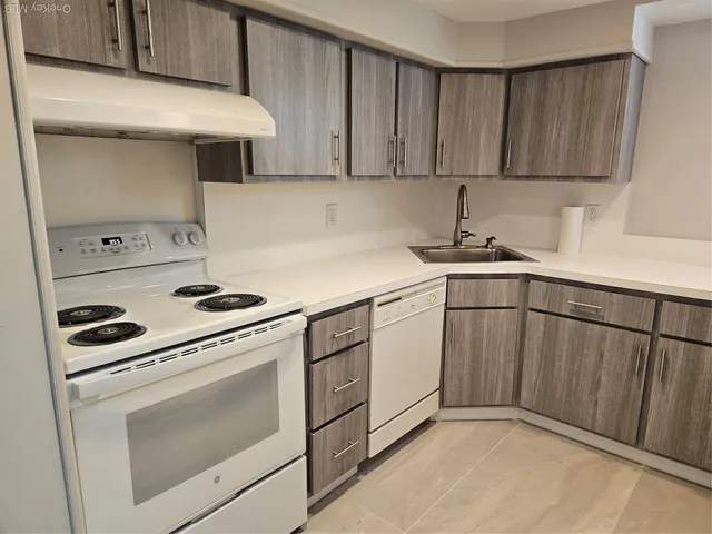 a kitchen with a stove cabinets and a sink
