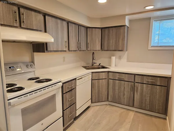 a kitchen with stainless steel appliances granite countertop a sink stove and cabinets