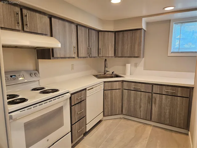 a kitchen with stainless steel appliances granite countertop a sink stove and cabinets