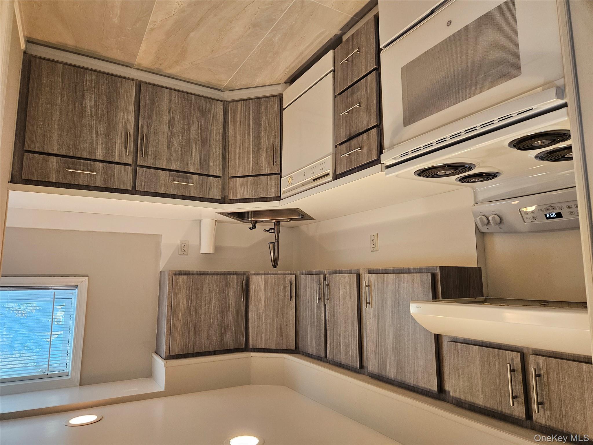 43 Hartman Hill Road Huntington, NY 11743 - Photo 3 of 10 a kitchen with stainless steel appliances granite countertop a sink stove and cabinets