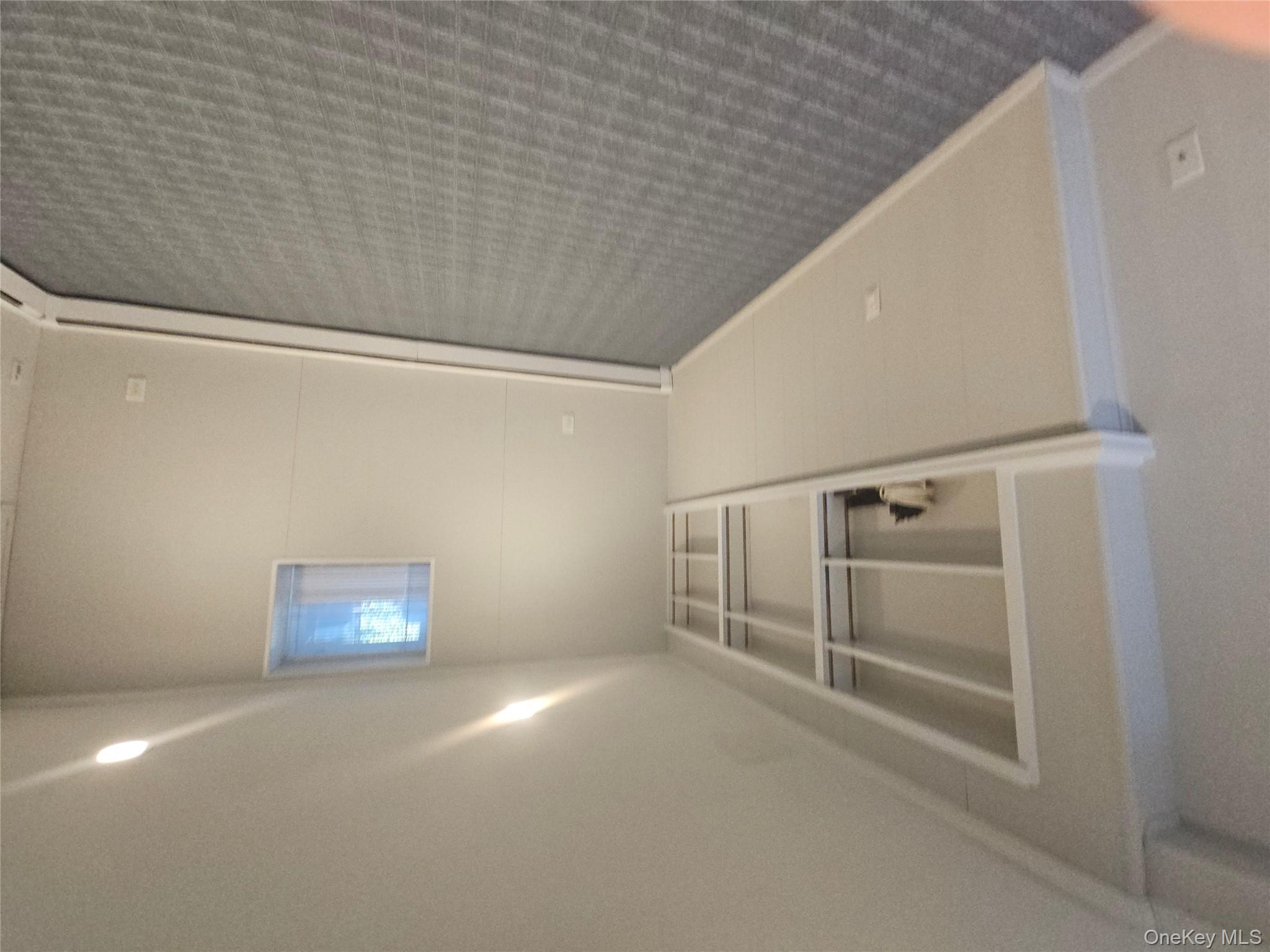 43 Hartman Hill Road Huntington, NY 11743 - Photo 6 of 10 an empty room with a empty space and window