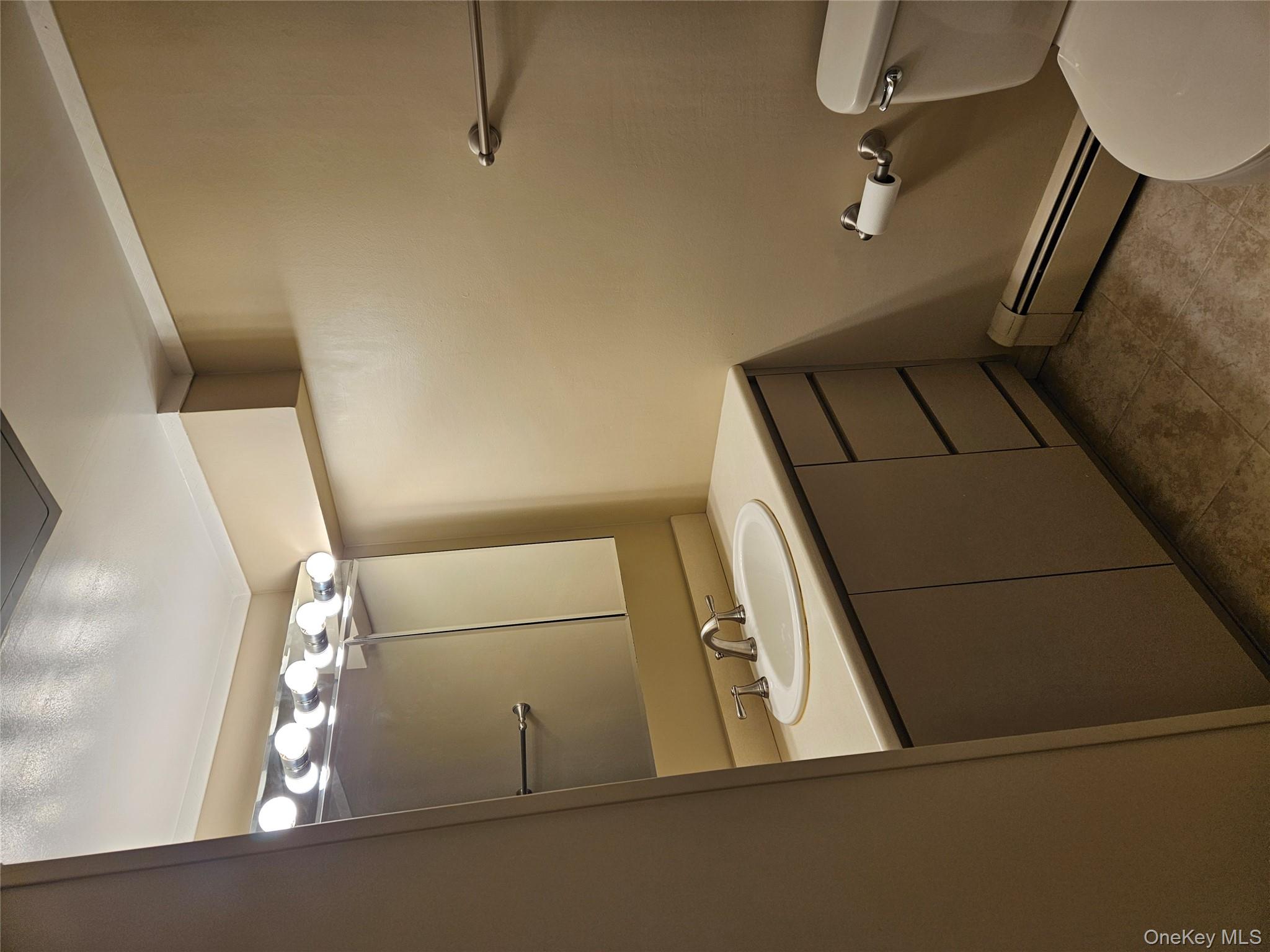 43 Hartman Hill Road Huntington, NY 11743 - Photo 10 of 10 a bathroom with a sink and mirror