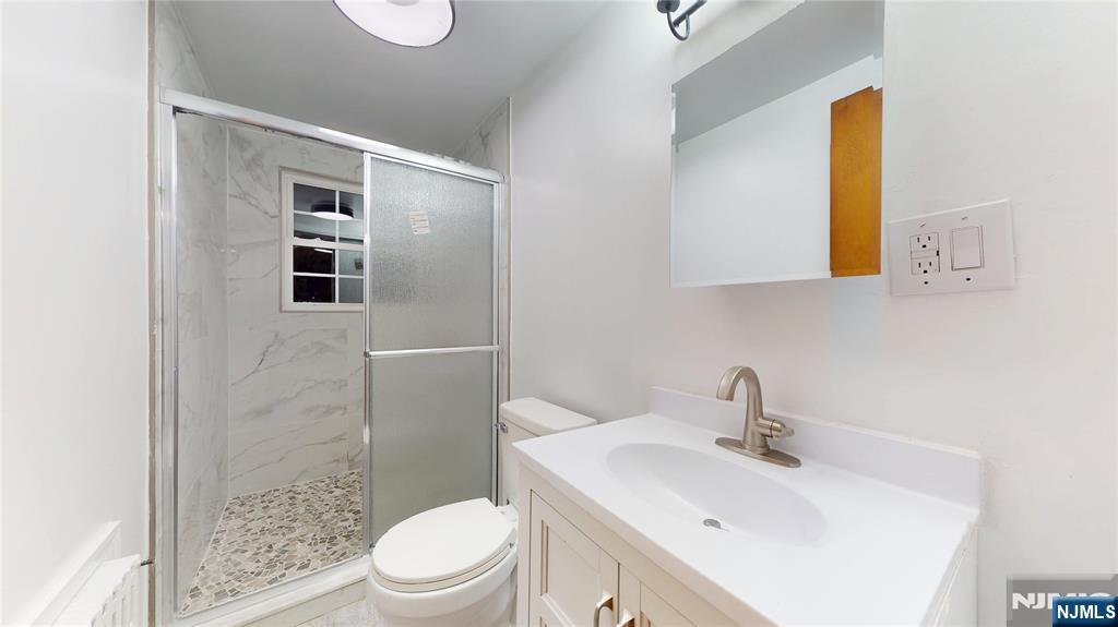 204 Philip Avenue, Unit 2 Elmwood Park, NJ 07407 - Photo 3 of 8 a bathroom with a sink a toilet and shower