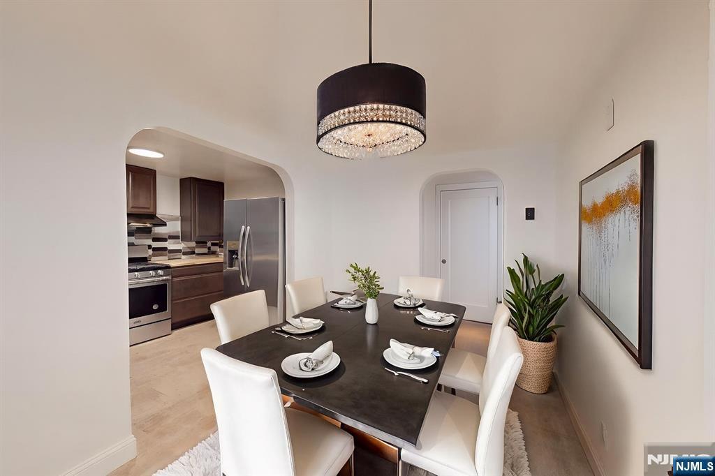 204 Philip Avenue, Unit 2 Elmwood Park, NJ 07407 - Photo 4 of 8 a view of a dining room with furniture and wooden floor