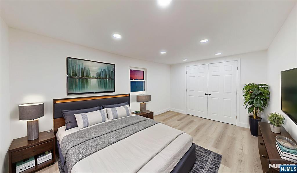 204 Philip Avenue, Unit 2 Elmwood Park, NJ 07407 - Photo 5 of 8 a bedroom with a large bed and a potted plant