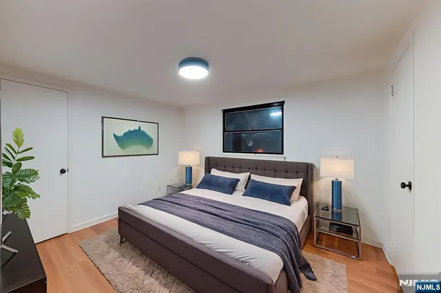 a bedroom with a bed and a potted plant