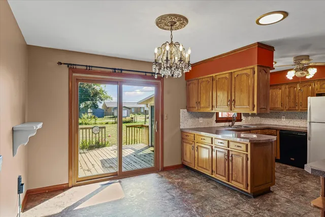 a spacious bathroom with a granite countertop sink a large mirror and a window
