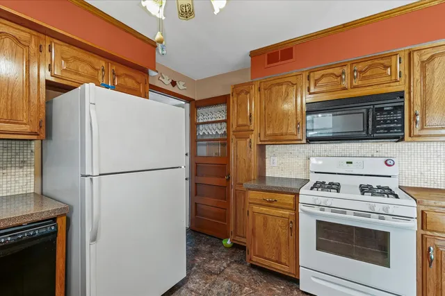a kitchen with a refrigerator stove and microwave