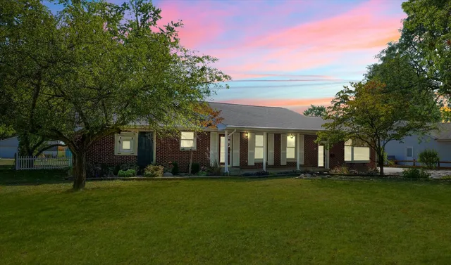 a front view of a house with a garden