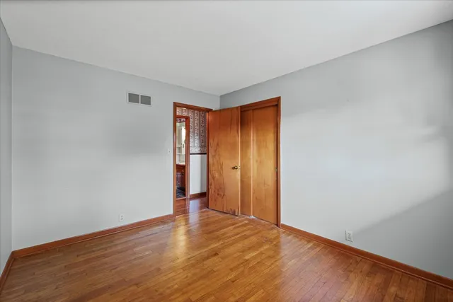 a view of an empty room and wooden floor