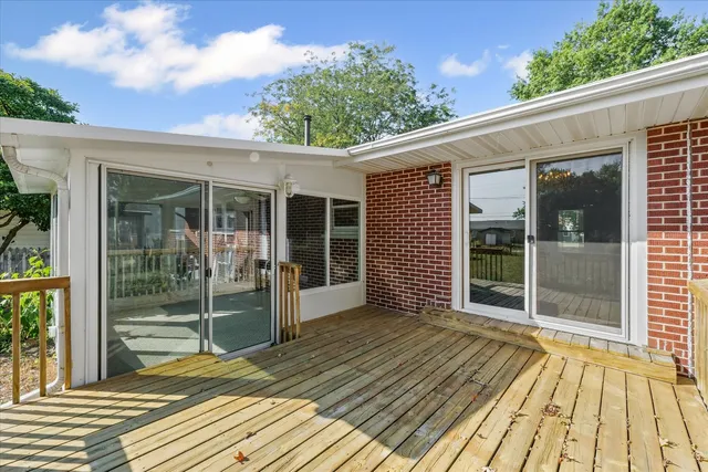 a view of balcony with wooden floor and fence