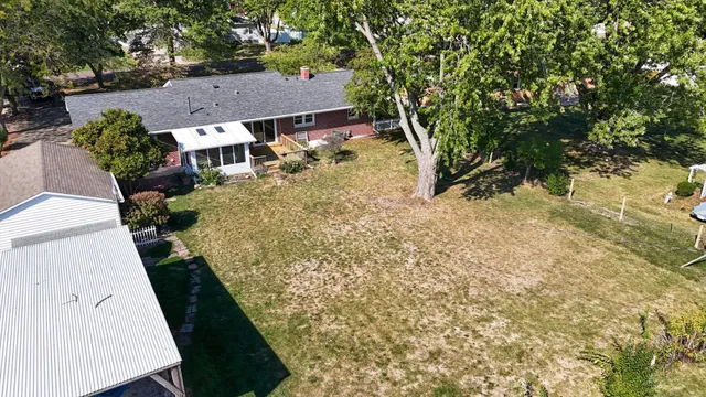 an aerial view of a house with a yard swimming pool and outdoor space