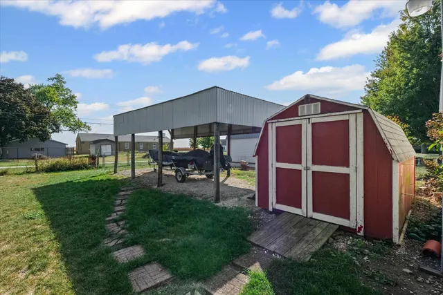 a backyard of a house with table and chairs