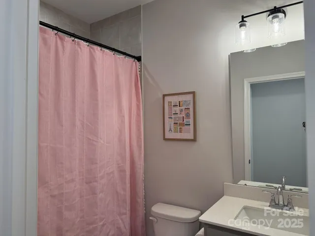 a bathroom with a shower curtain and a sink