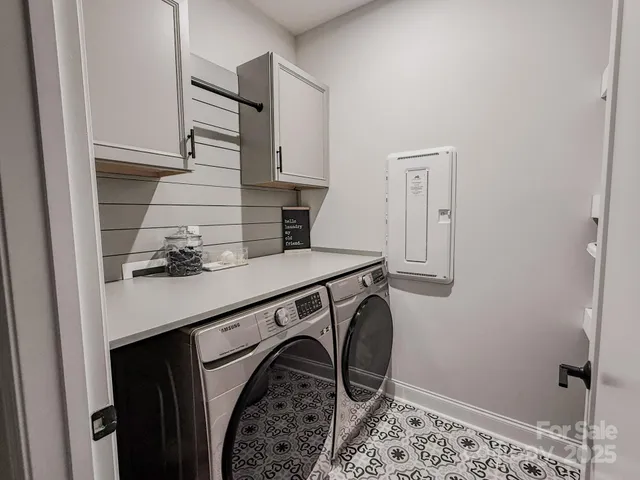 a utility room with sink dryer and washer