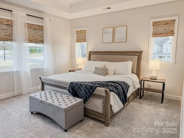 a bedroom with a bed lamp and a window