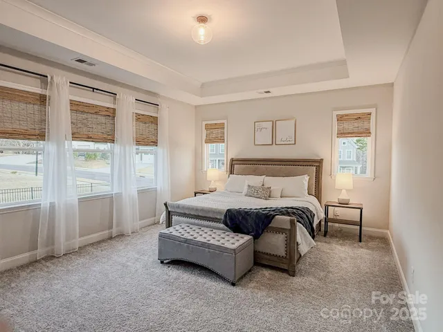 a spacious bedroom with a bed and a window