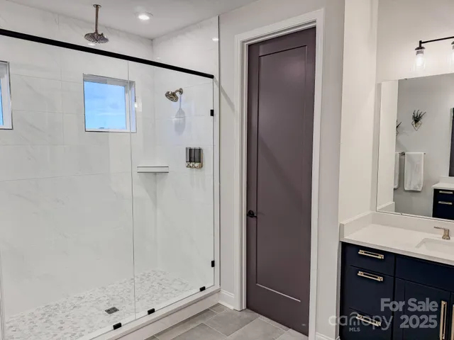 a bathroom with a shower and a sink