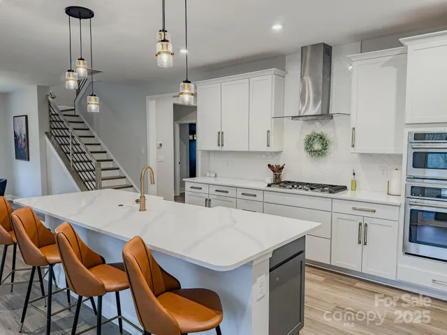 a kitchen that has a cabinets a stove and a table