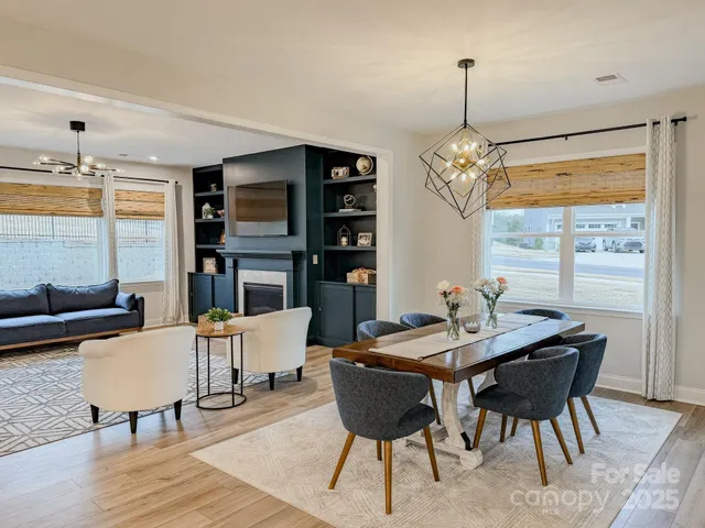 a view of a dining room with furniture window and wooden floor