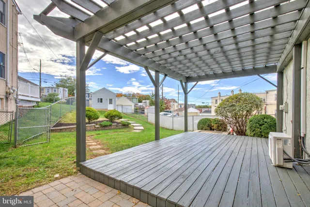 a view of a backyard with wooden floor and floor to ceiling window