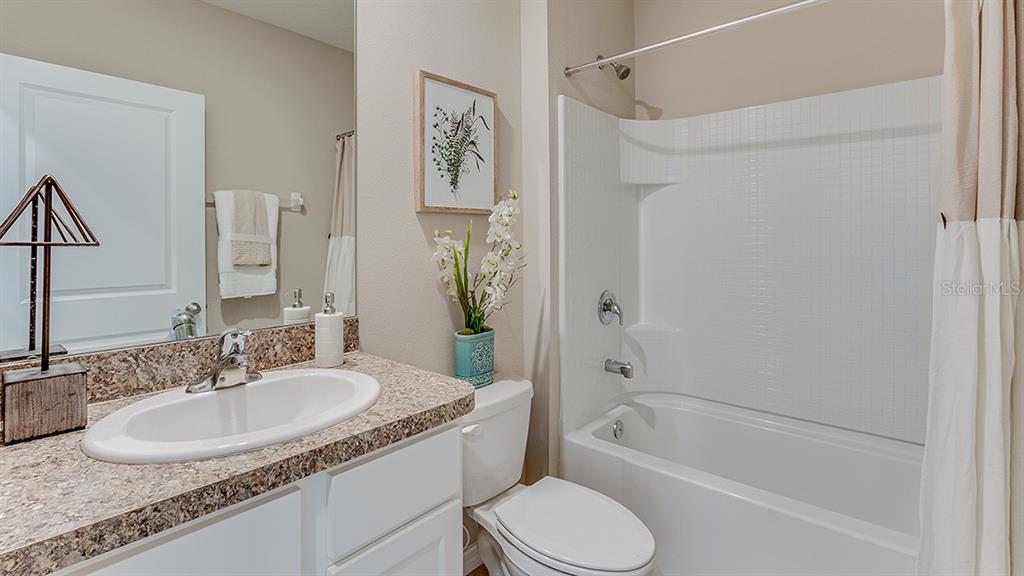 18106 Wheathouse Place Lakewood Ranch, FL 34211 - Photo 14 of 43 a bathroom with a granite countertop sink toilet and shower