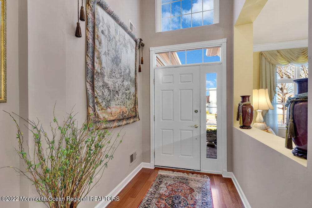 41 Muirfield Road Jackson, NJ 08527 - Photo 8 of 69 a view of a hallway with wooden floor and a potted plant