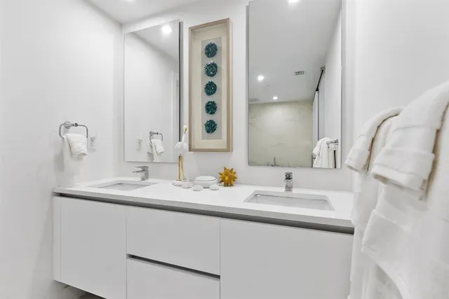 a bathroom with a double vanity sink and a mirror