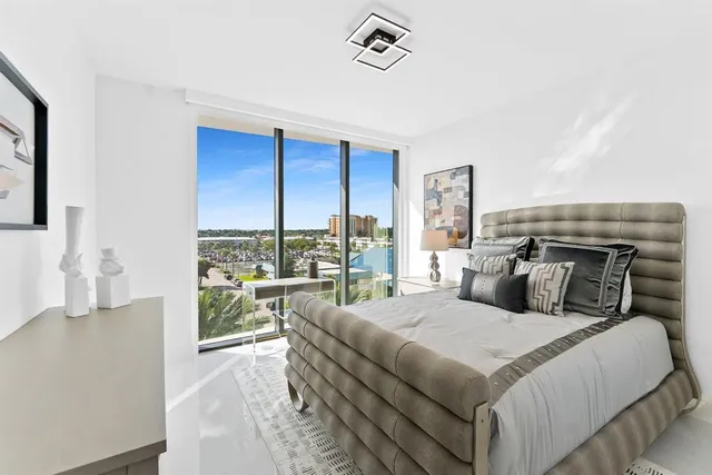 a bedroom with a large bed and a balcony