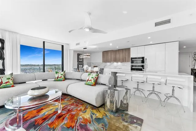 a living room with furniture and kitchen view