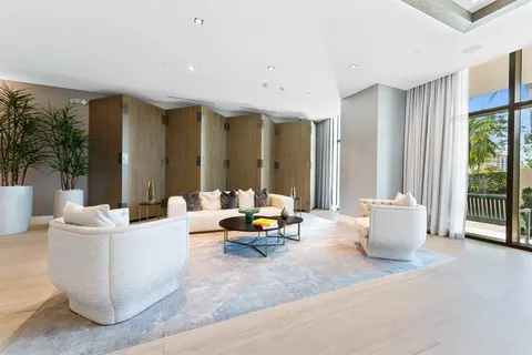 a living room with furniture and large windows