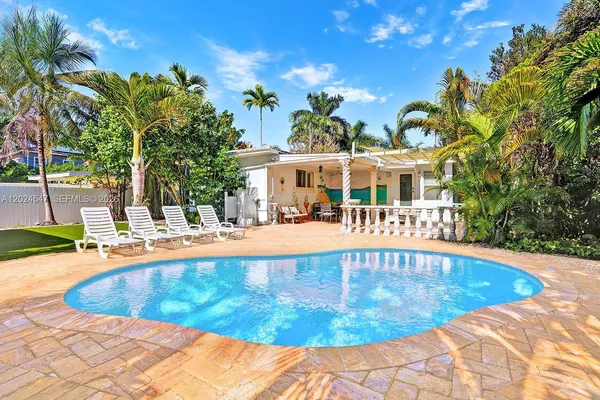 a view of a swimming pool with an outdoor seating