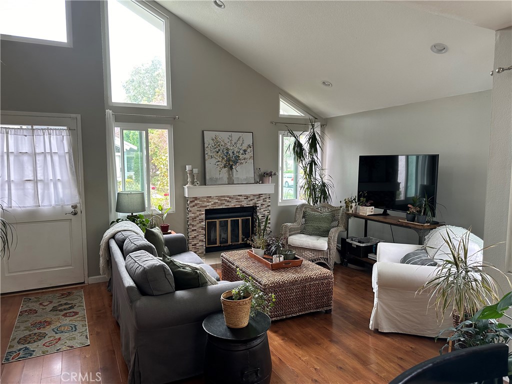 39 Wintermist Irvine, CA 92614 - Photo 8 of 14 a living room with furniture a flat screen tv and a fireplace