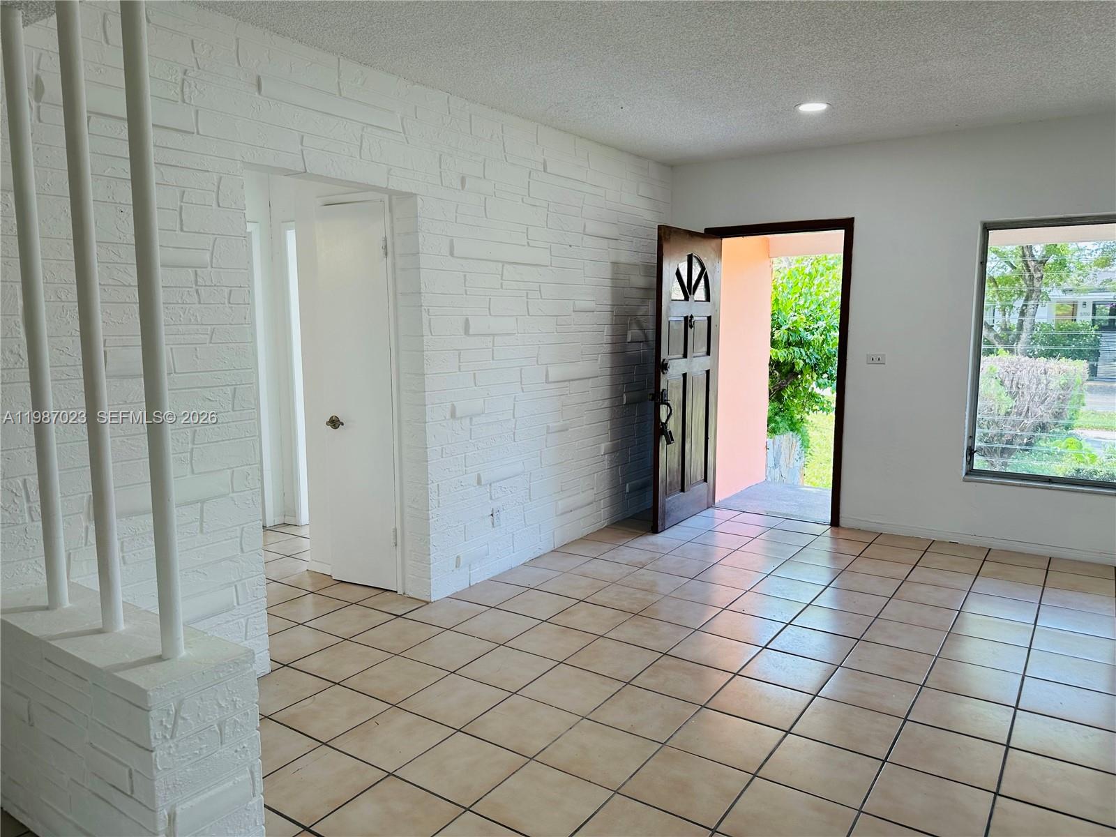 5705 Southwest 39th Street Miami, FL 33155 - Photo 7 of 26 an empty room with windows