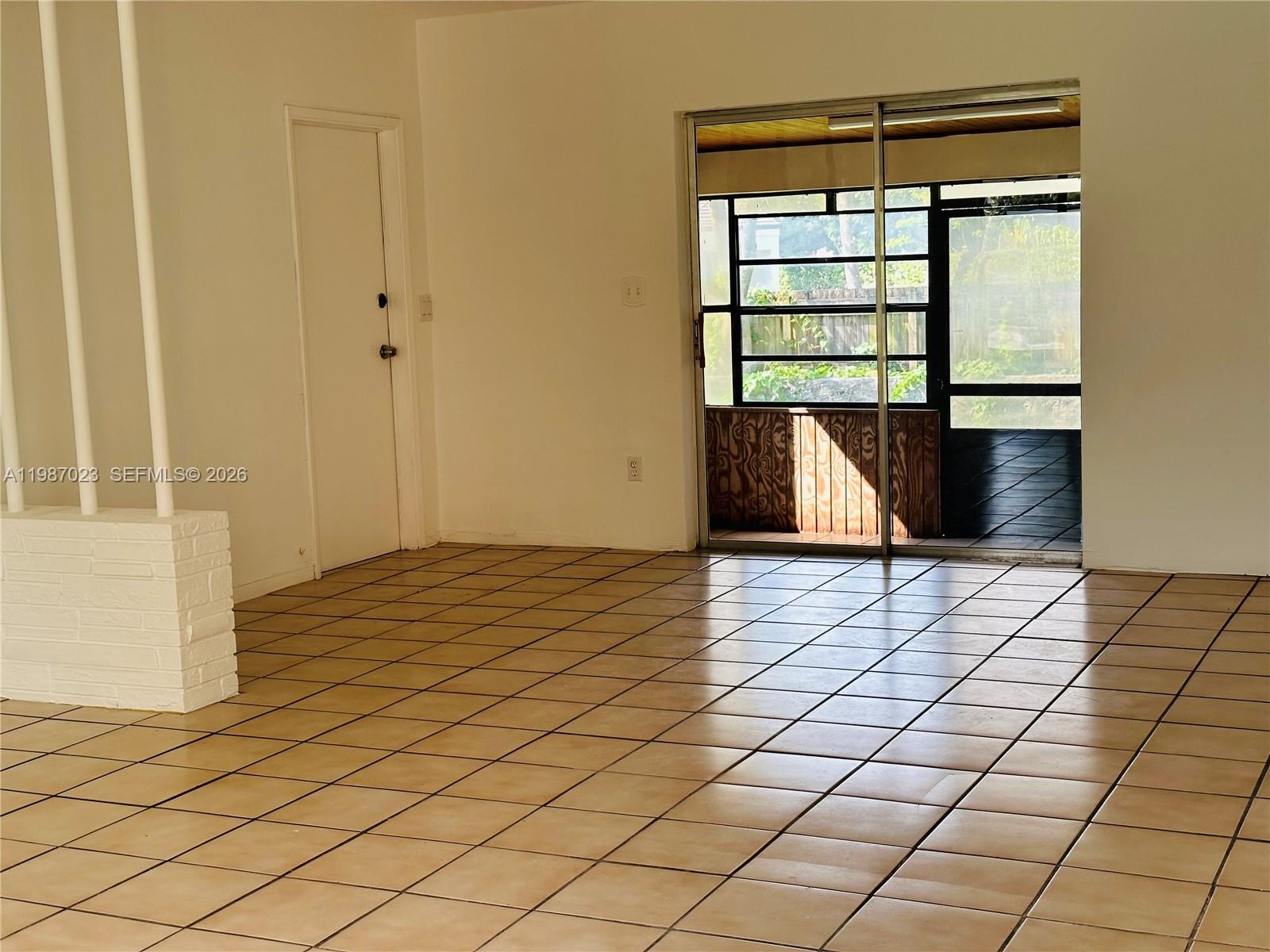 5705 Southwest 39th Street Miami, FL 33155 - Photo 8 of 26 a view of an empty room with wooden floor and a window
