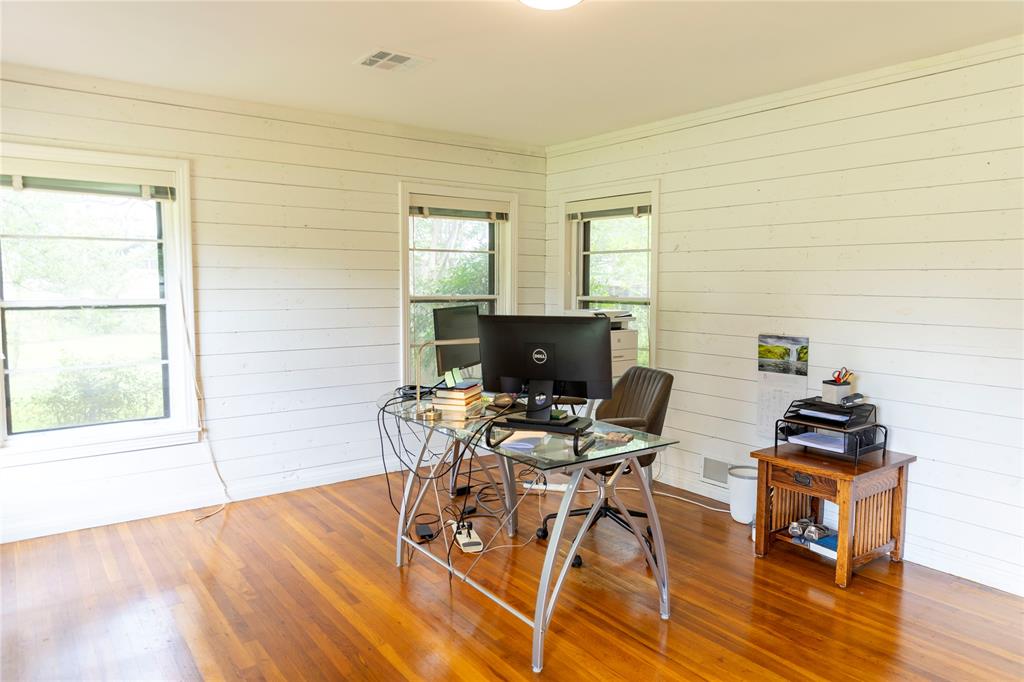 3228 Colcord Avenue Waco, TX 76707 - Photo 24 of 29 Room featuring wood-finish flooring, two large windows, white shiplap walls, and a recessed ceiling light fixture