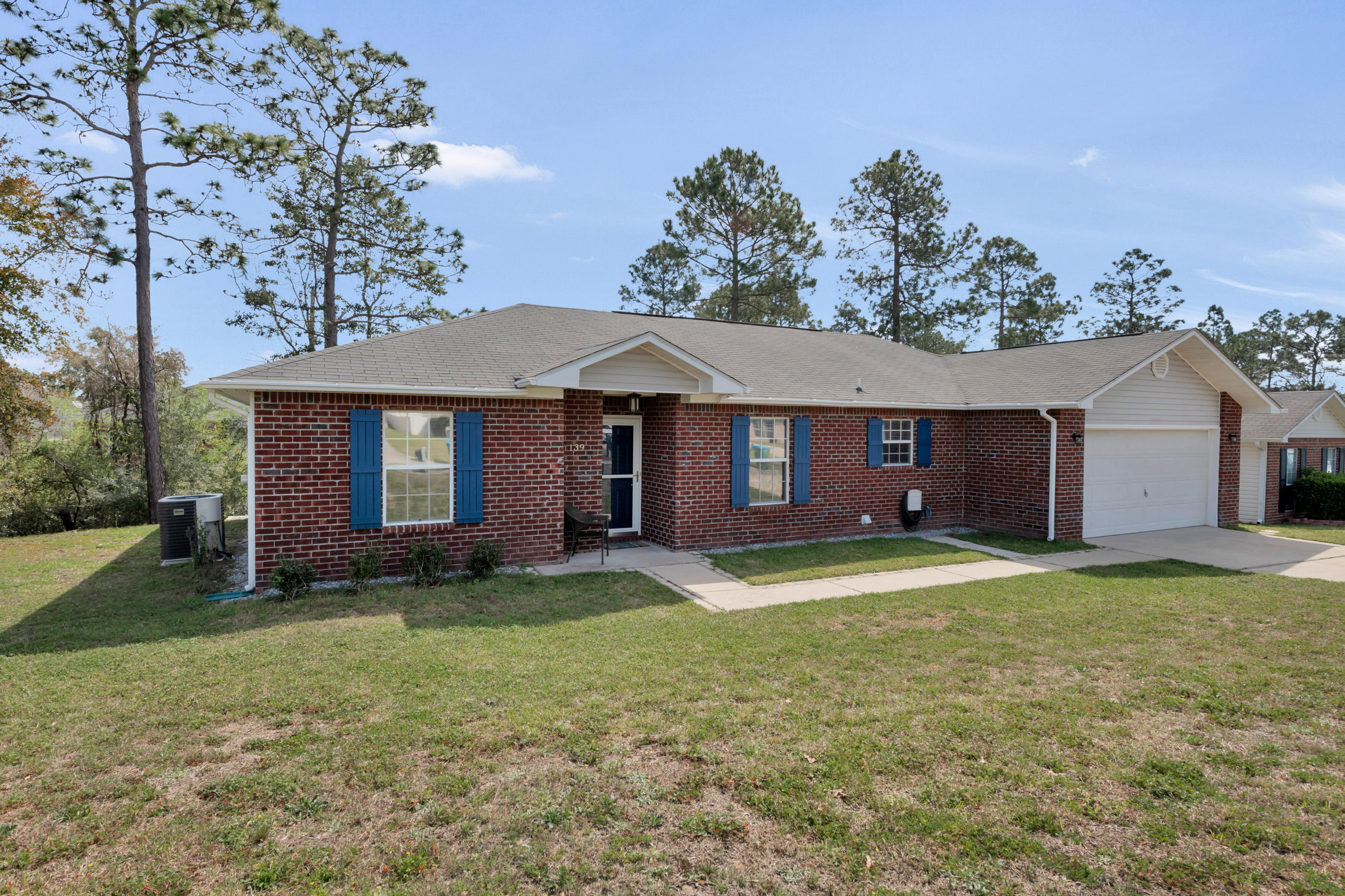 139 Sandstone Trail Crestview, FL 32539 - Photo 1 of 36 a front view of a house with a yard
