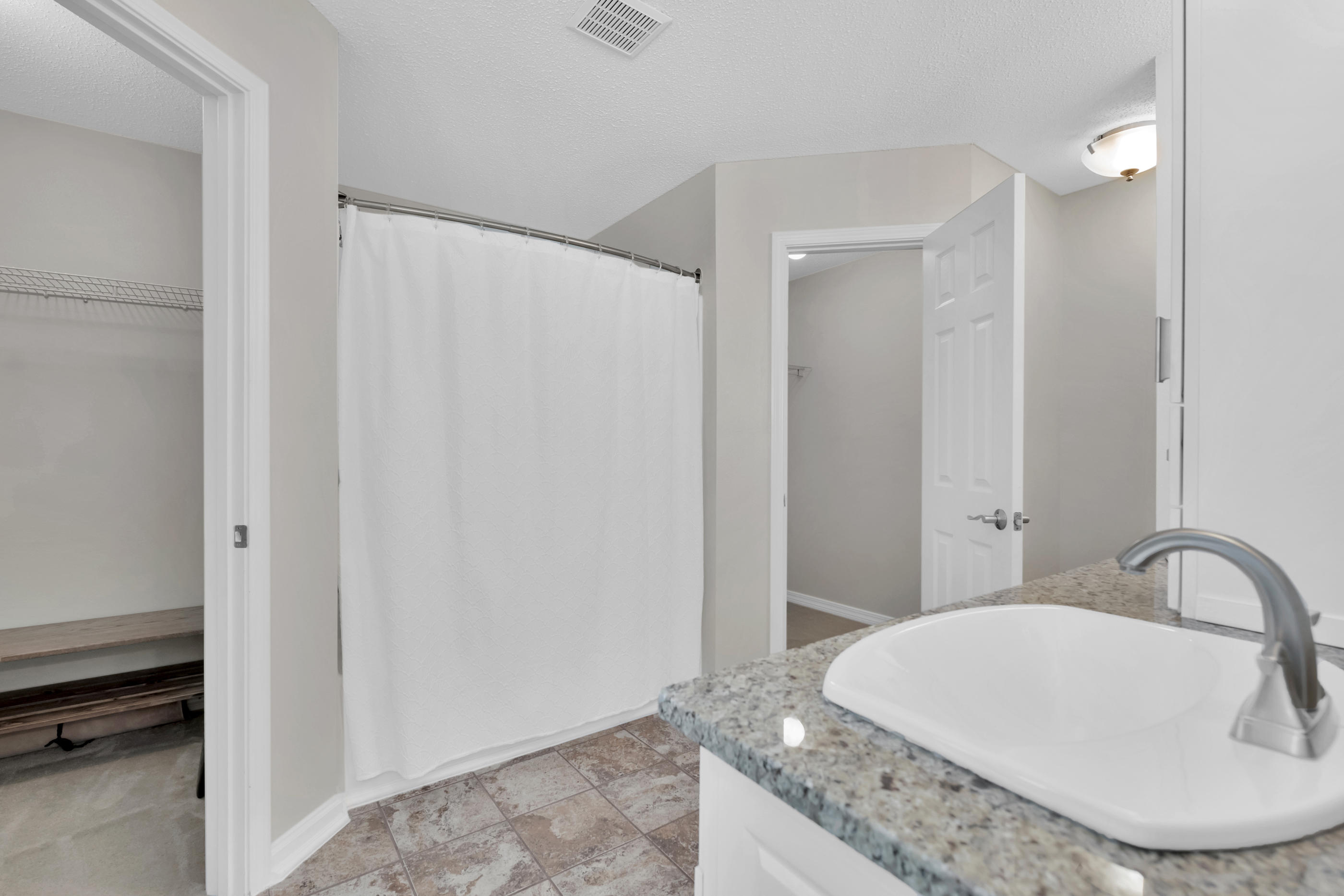 139 Sandstone Trail Crestview, FL 32539 - Photo 19 of 36 a bathroom with a granite countertop sink and a mirror
