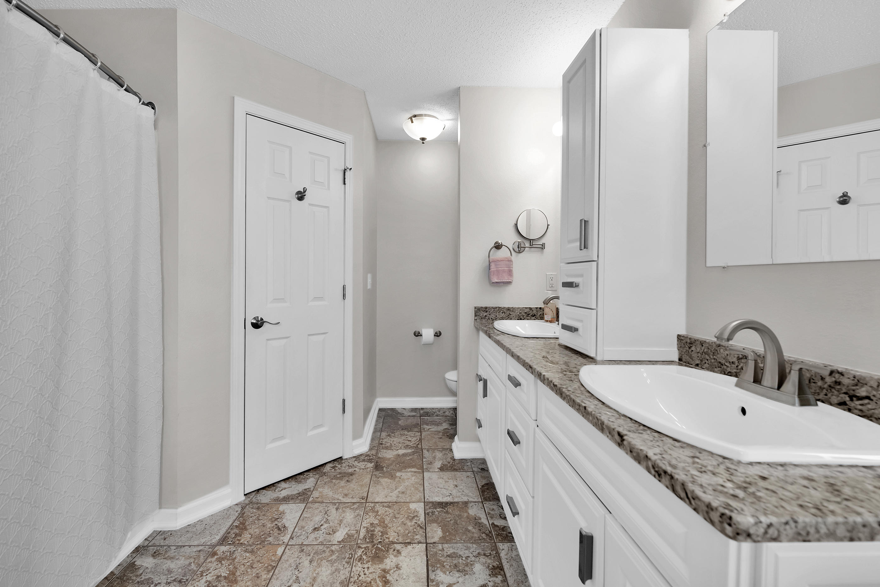 139 Sandstone Trail Crestview, FL 32539 - Photo 20 of 36 a bathroom with a granite countertop sink mirror and a bathtub