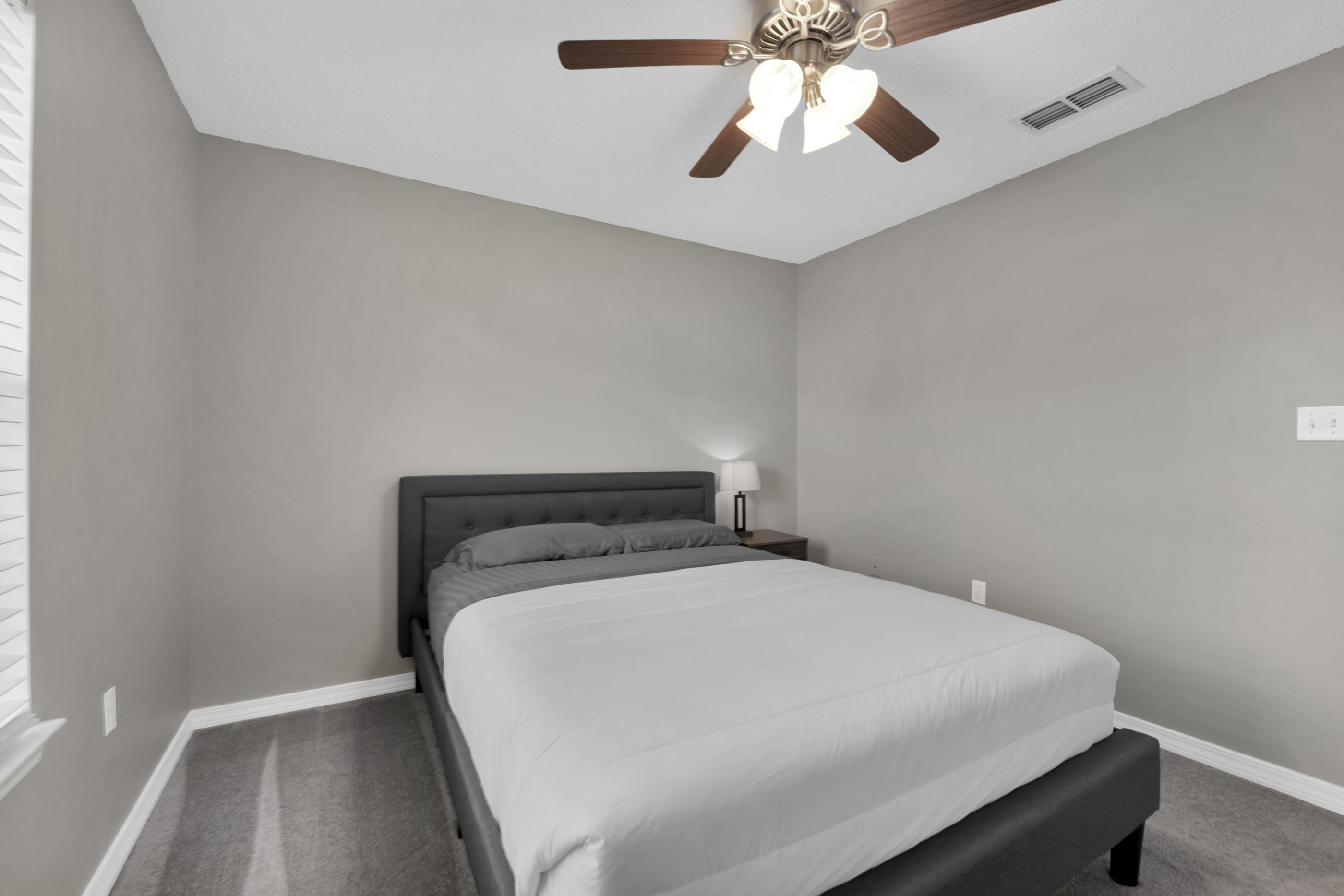 139 Sandstone Trail Crestview, FL 32539 - Photo 24 of 36 a bed sitting in a bedroom next to a window
