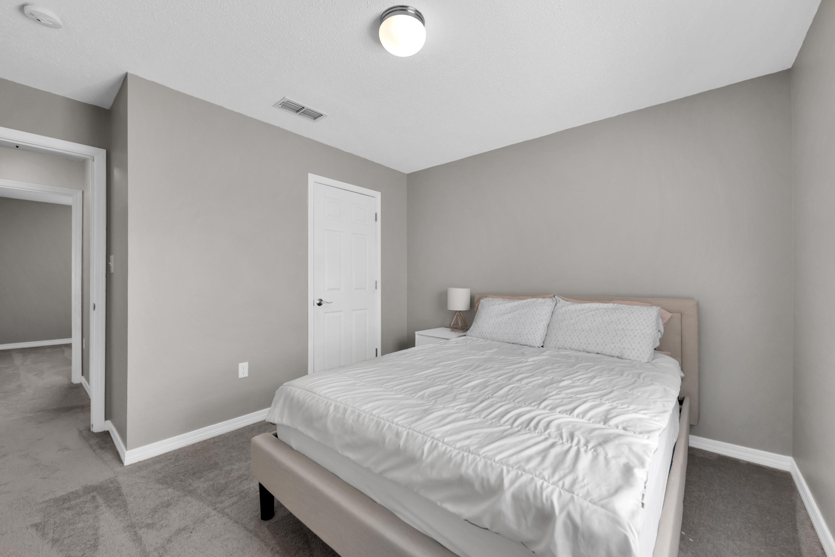 139 Sandstone Trail Crestview, FL 32539 - Photo 26 of 36 a large bed sitting in a bedroom next to a bathroom