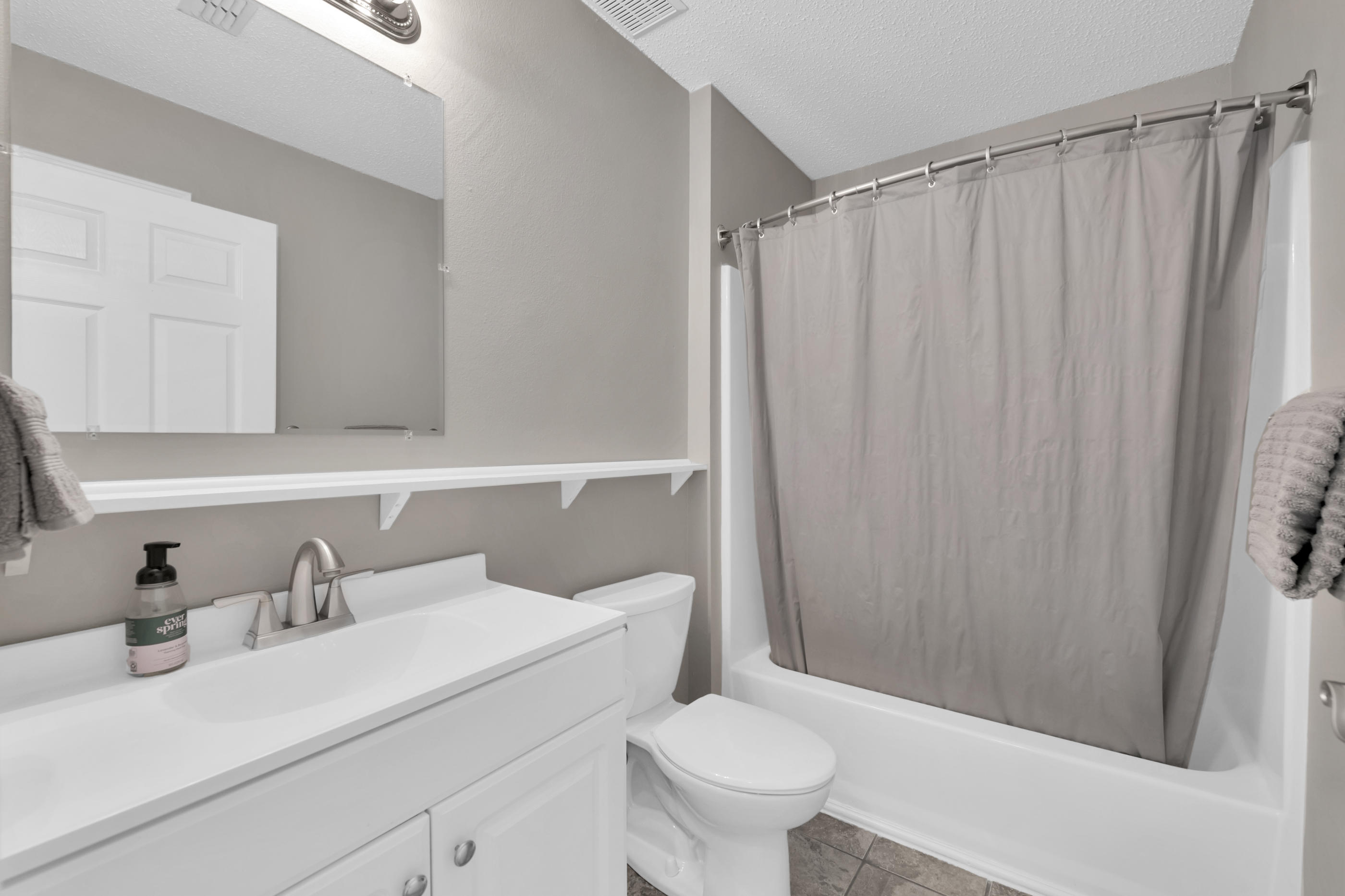 139 Sandstone Trail Crestview, FL 32539 - Photo 27 of 36 a bathroom with a sink a toilet and shower curtain