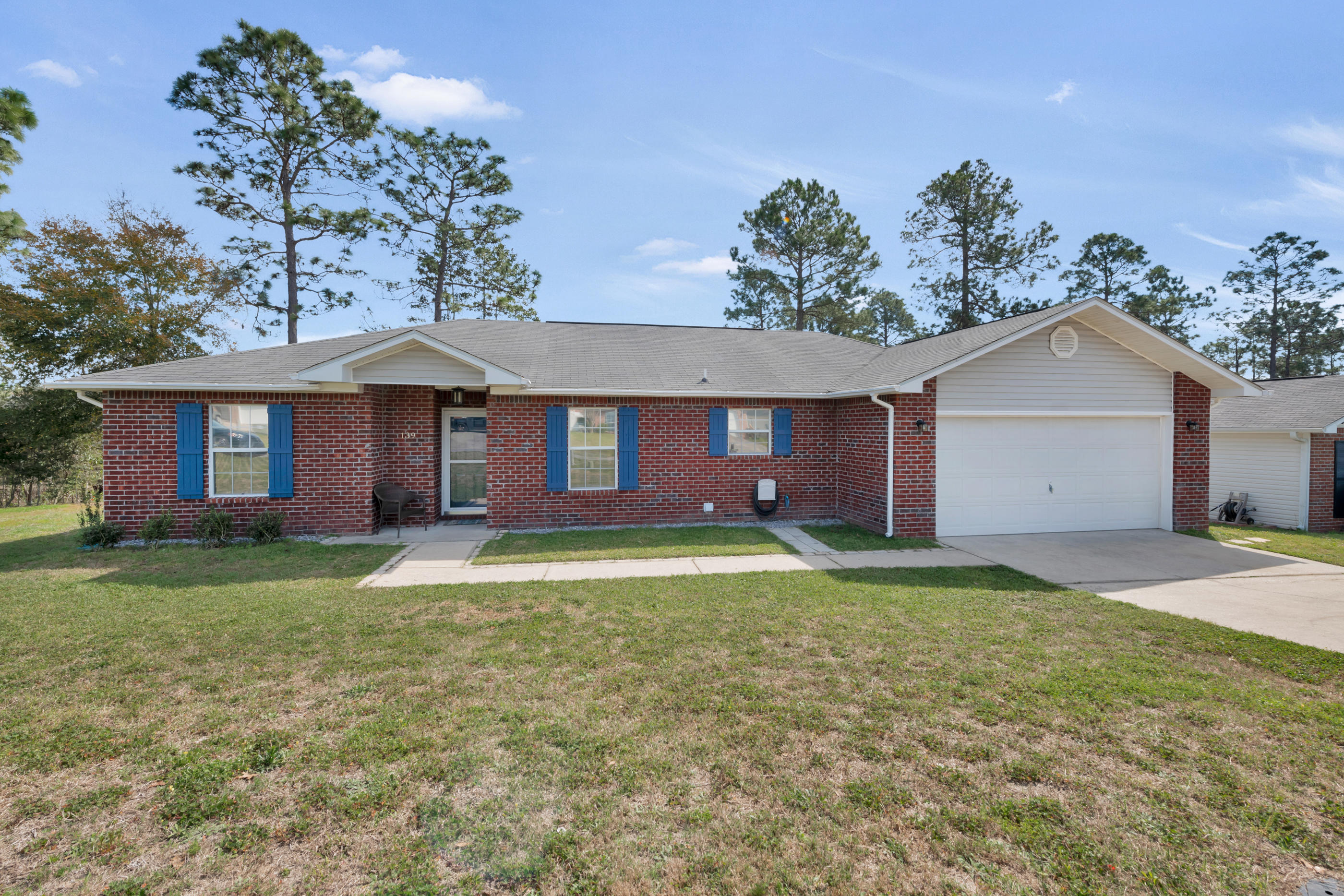 139 Sandstone Trail Crestview, FL 32539 - Photo 35 of 36 a front view of a house with a yard and garage