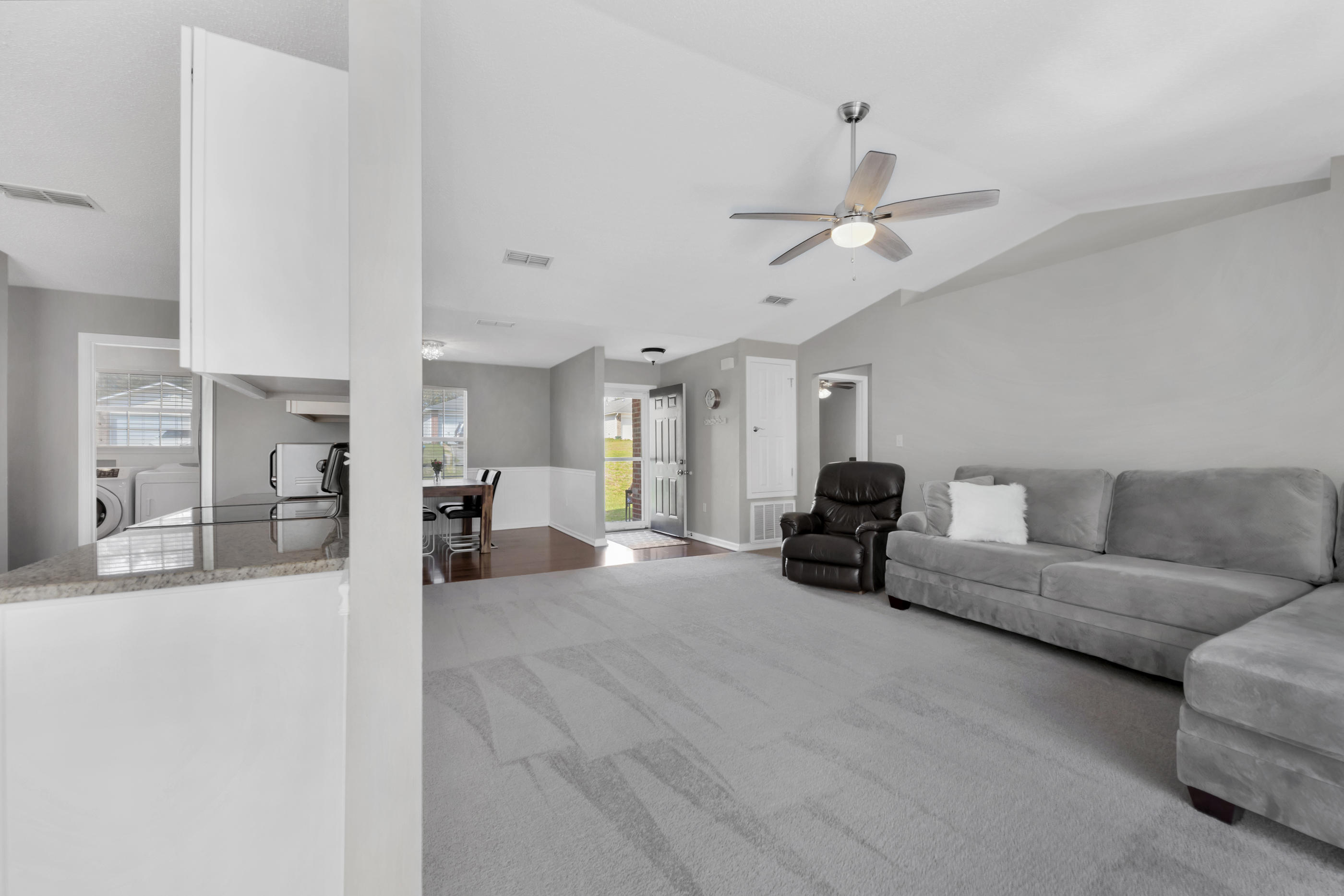 139 Sandstone Trail Crestview, FL 32539 - Photo 8 of 36 a living room with furniture and a chandelier