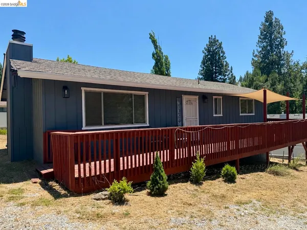 a view of a house with a wooden fence