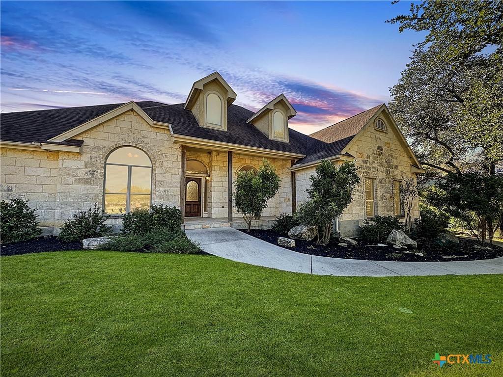 a front view of a house with garden