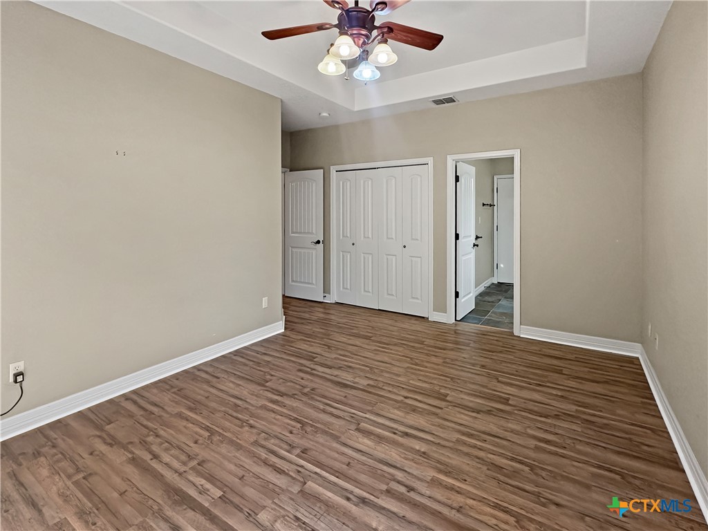 386 Wentworth Spring Branch, TX 78070 - Photo 13 of 39 a view of an empty room with wooden floor and a ceiling fan